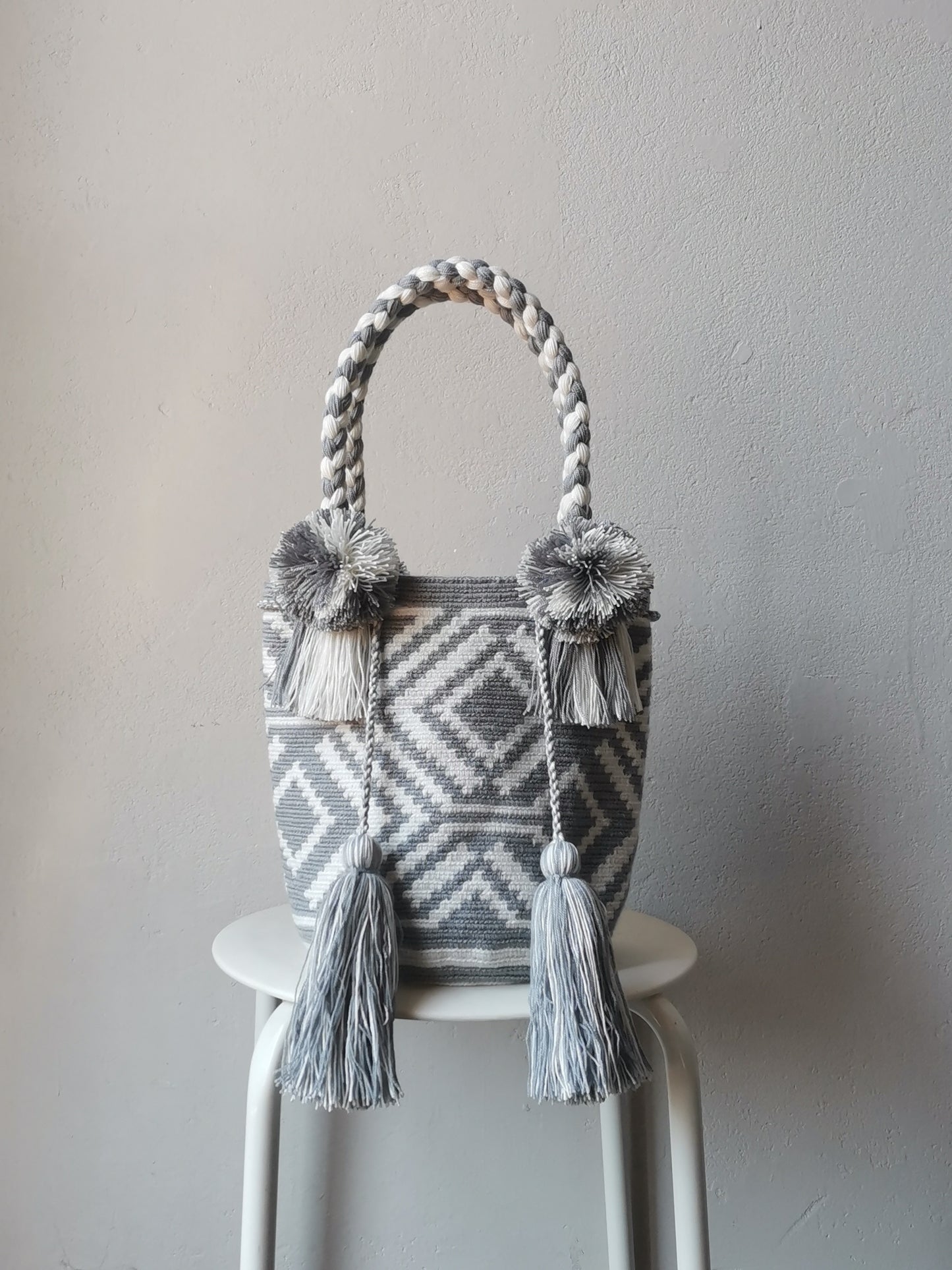 Gray and white M mochila handbag