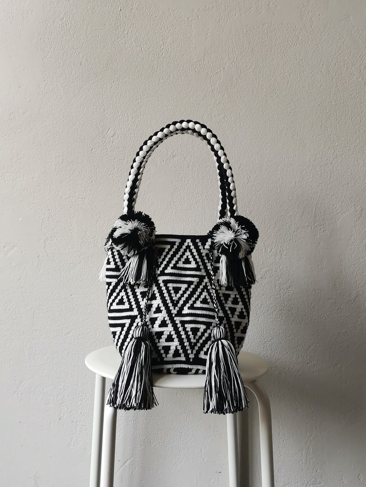 Black and white M mochila handbag